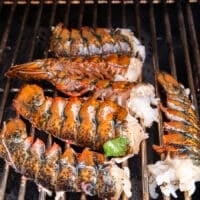 The lobster placed on the grill, meat side down