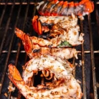 The flipped lobster tails on the grill with perfect grill marks