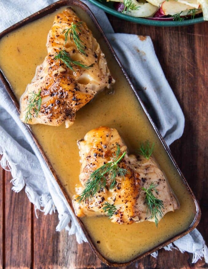 plated cod fish with lemon garlic butter sauce