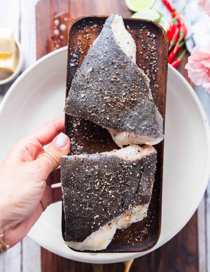 seasoning the fish to show how we can make lemon garlic butter sauce for fish