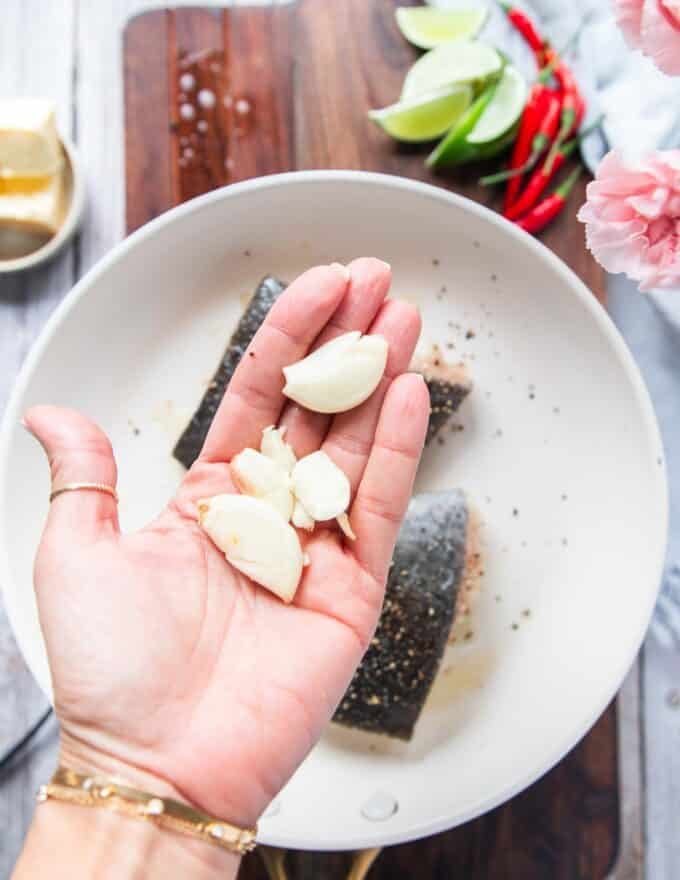 whole smashed garlic cloves added to a pan