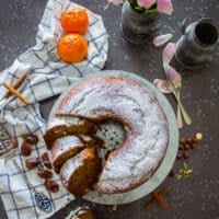 date cake with powdered sugar on a board sliced and perfect texture showing