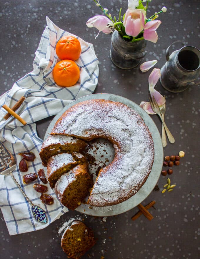 date cake with powdered sugar on a board sliced and perfect texture showing 