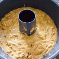 The batter poured into the greased cake pan and ready to bake