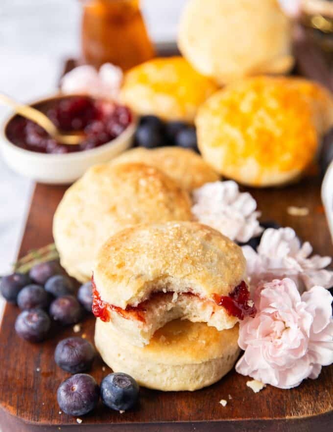 A bitten piece of mayo biscuit stuffed with jam showing the way to serve is sweet