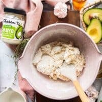 a spatula mixing the biscuits dough in the bowl until it comes together