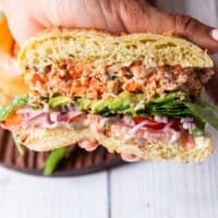 Juicy homemade salmon burger with lettuce and aioli cut in half