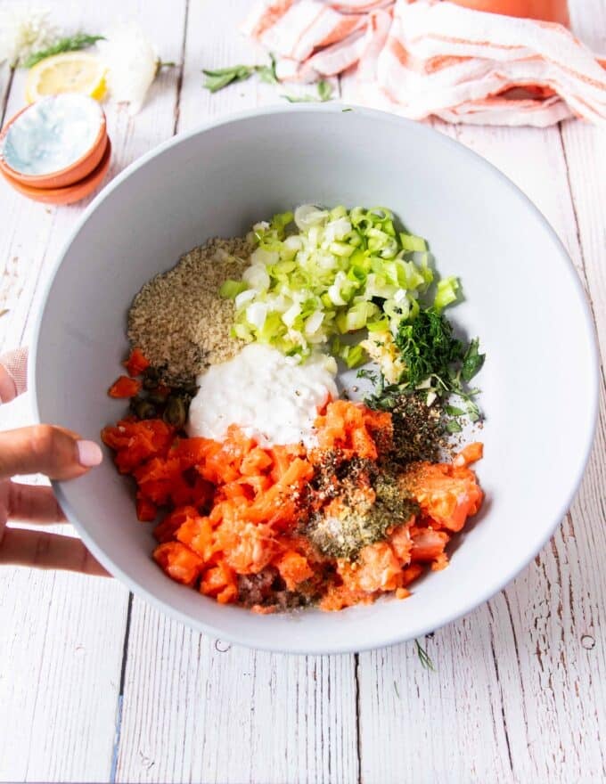 All the salmon burgers ingredients are added into a bowl 