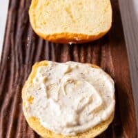 Lemon aioli is spread over the buns to assemble the salmon burgers