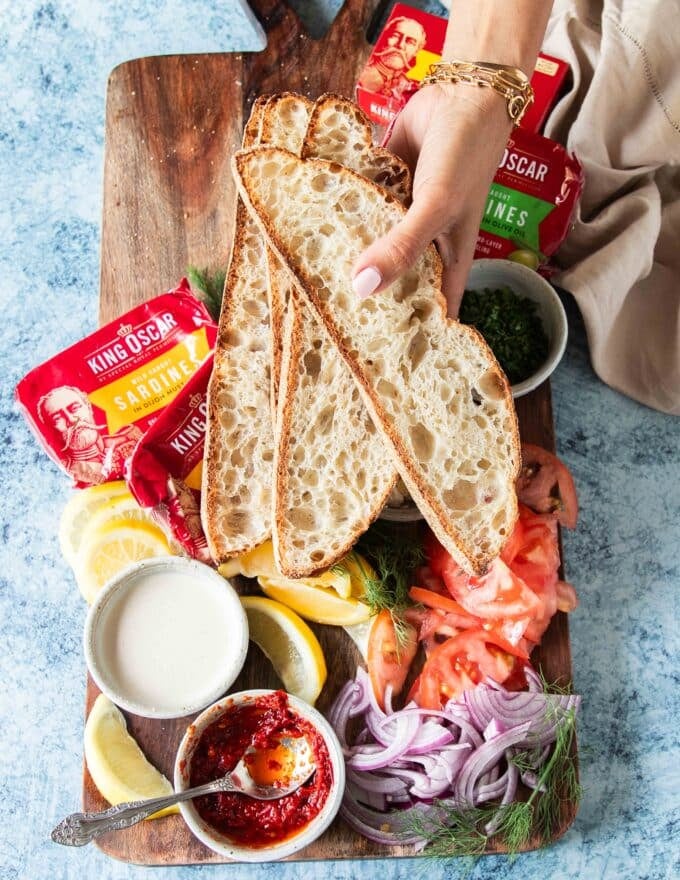 A hand holding some slices of sourdough