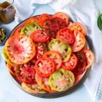overlapping multicolored heirloom tomatoes on a bowl