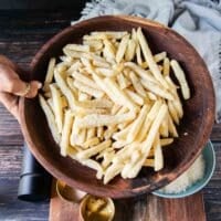 Frozen French Fries in a bowl or fresh potatoes to make french fries