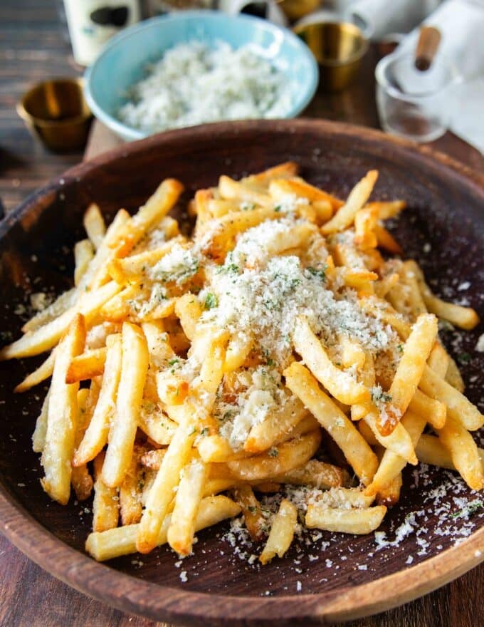 half of the parmesan mixture is added first to flavor the fries 