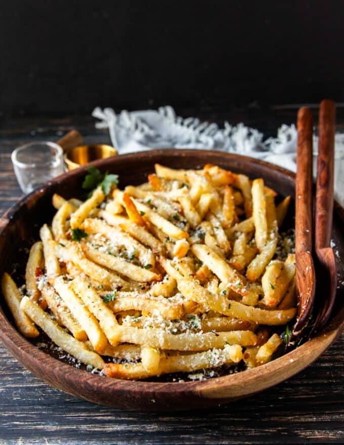 close up of truffle fries on a bowl with parsley