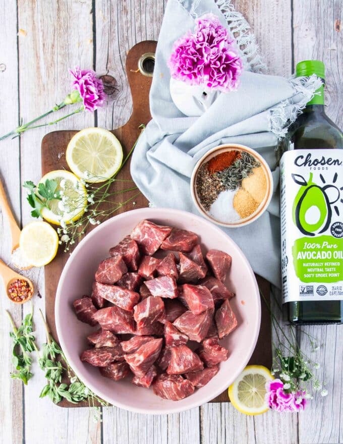 Ingredients to make air fryer steak bites on a board 