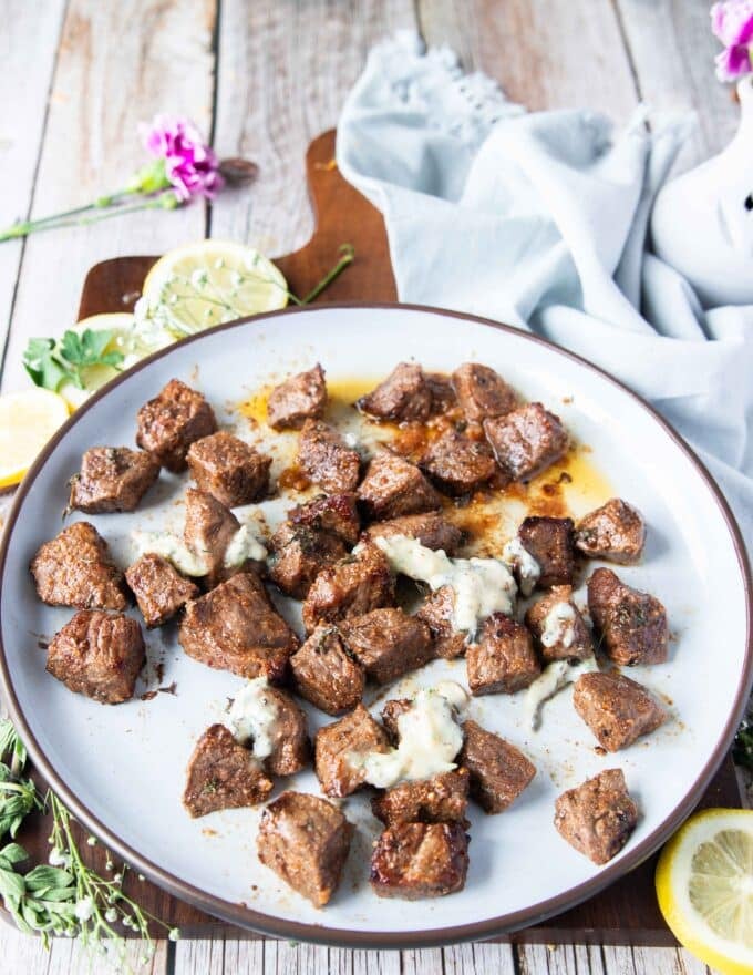 butter poured all over the air fryer steak bites