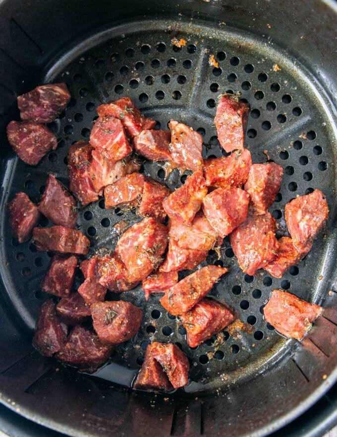 steak bites in an air fryer basket 