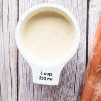 Creamy dressing for the broccoli salad in a small bowl ready
