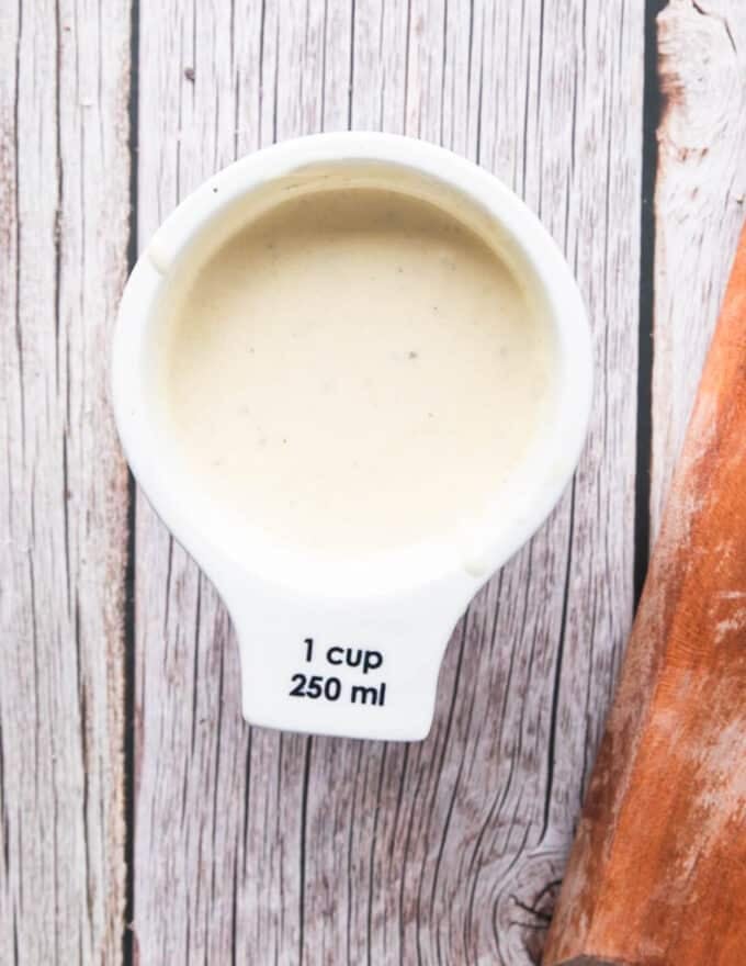 Creamy dressing for the broccoli salad in a small bowl ready 
