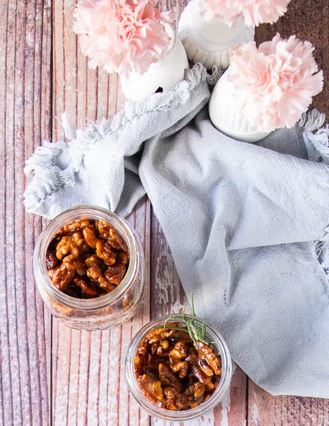 two jars of different flavored candied walnuts ready to store
