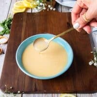 luscious creamy citrus beurre blanc with a spoon showing the silky texture