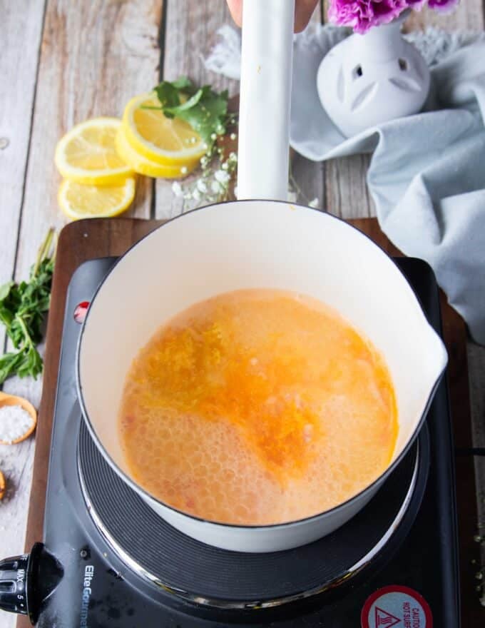 citrus zest is added to the pot to make citrus beurre blanc