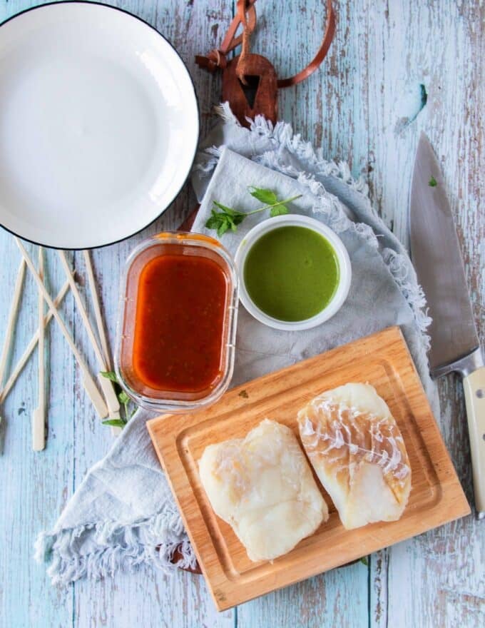 Ingredients to make halibut recipe on a board