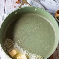 making bechamel sauce for mac and cheese starting with butter in a pan