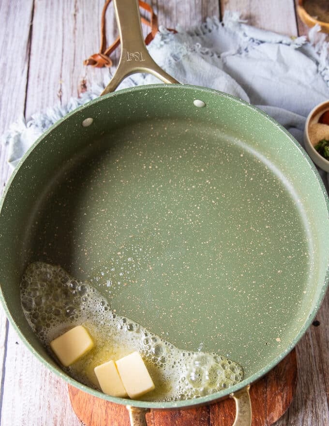 making bechamel sauce for mac and cheese starting with butter in a pan