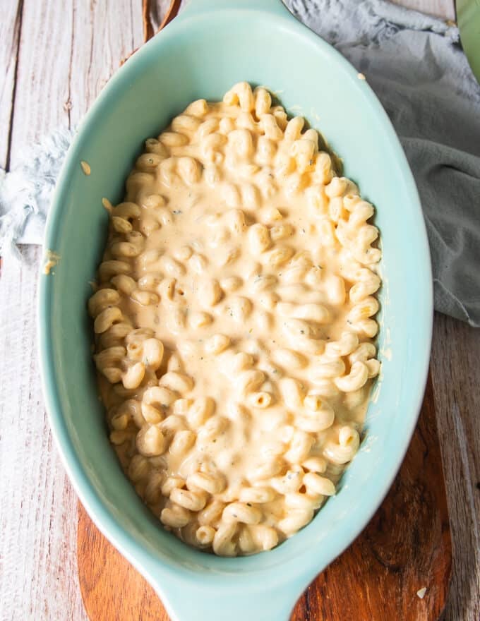 half the pasta in an oven safe dish spread 