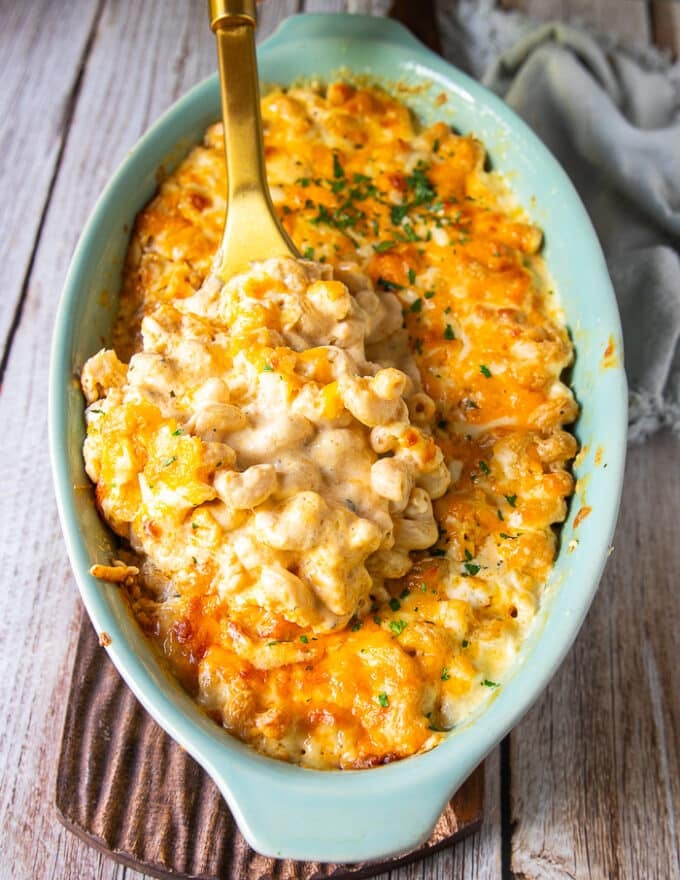 the best mac and cheese recipe showing creamy and luscious pasta in the sauce with cheesy pulls