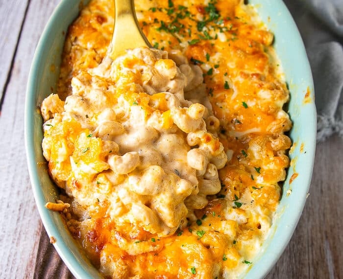 the best mac and cheese recipe showing creamy and luscious pasta in the sauce with cheesy pulls