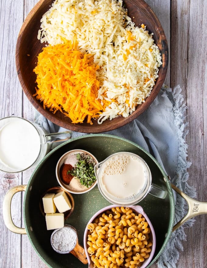 detailed mac and cheese recipe ingredients on a board each in a small bowl 