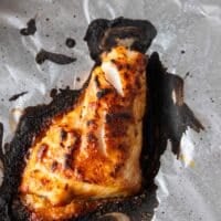 golden brown miso sea bass out of the oven on a baking sheet