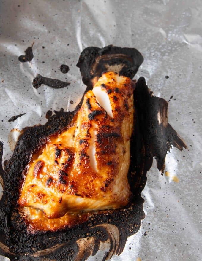 golden brown miso sea bass out of the oven on a baking sheet 