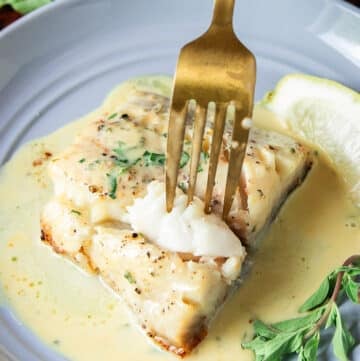 succulent flaky chilean sea bass with a fork showing how juicy it is