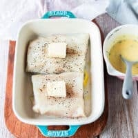 Butter is added over each fillet in the baking dish right before baking