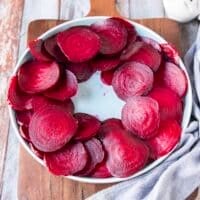 Sliced beets arranged on a plate leaving the middle empty