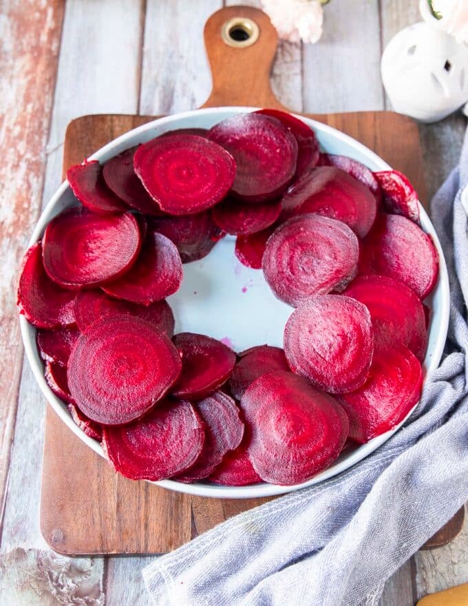 Sliced beets arranged on a plate leaving the middle empty