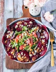 Beet Carpaccio on a plate with blue cheese crumbles and walnuts