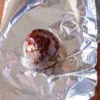 one beetroot is placed in a foil drizzled with olive oil and salt to roast