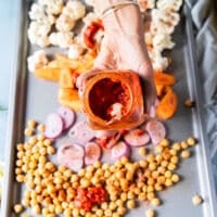 harissa is added over the veggies before roasting