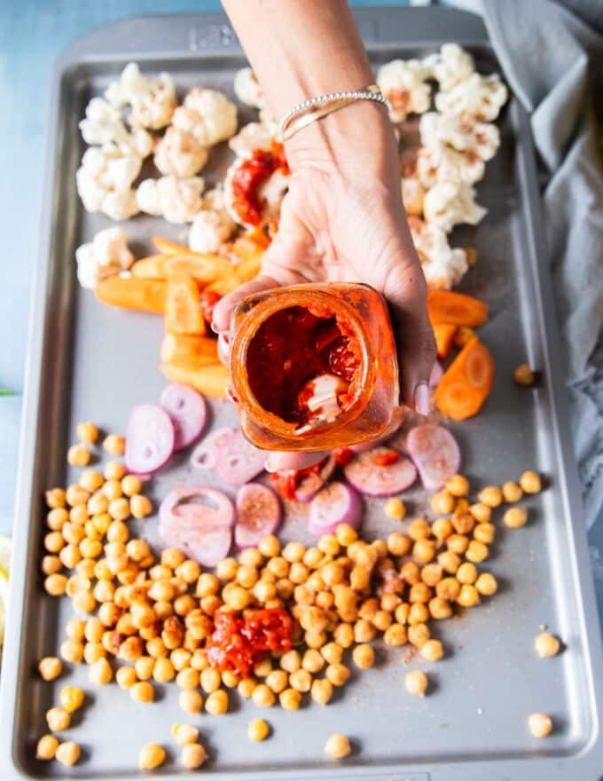 harissa is added over the veggies before roasting