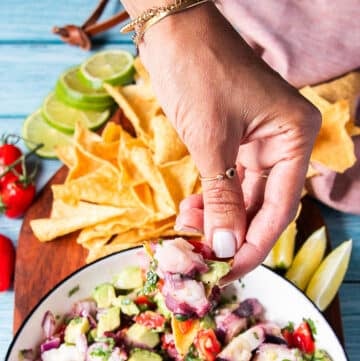 close up of a tortilla chip loaded with octopus ceviche