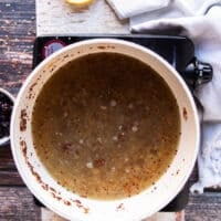 Broth is added to cook and steam the quinoa pilaf