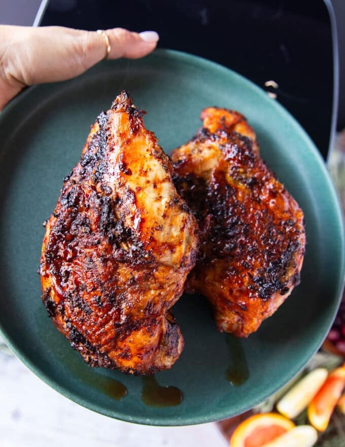 turkey breasts removed fro the air fryer on to a plate to rest 