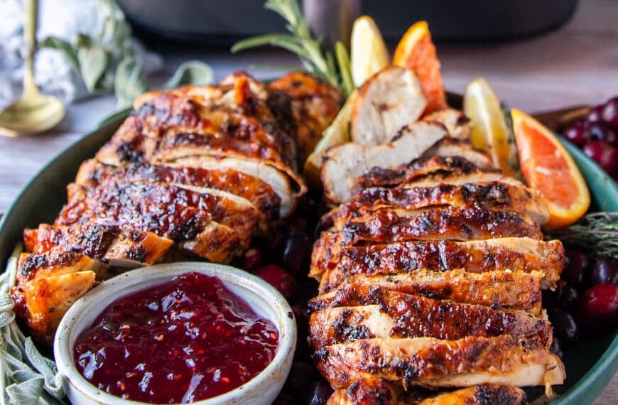 Juicy air fryer turkey breasts, sliced with crispy skin served with cranberry sauce