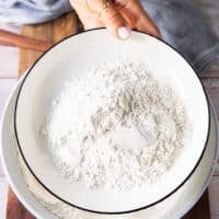 I cup of the dried flour mixture is removed on the side in a separate plate to dredge the fish in