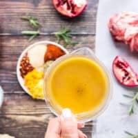 Stock being poured in the roasting pan