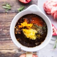 The balsalmic sauce is mixed in a bowl with citrus zests, olive oil and seasoning